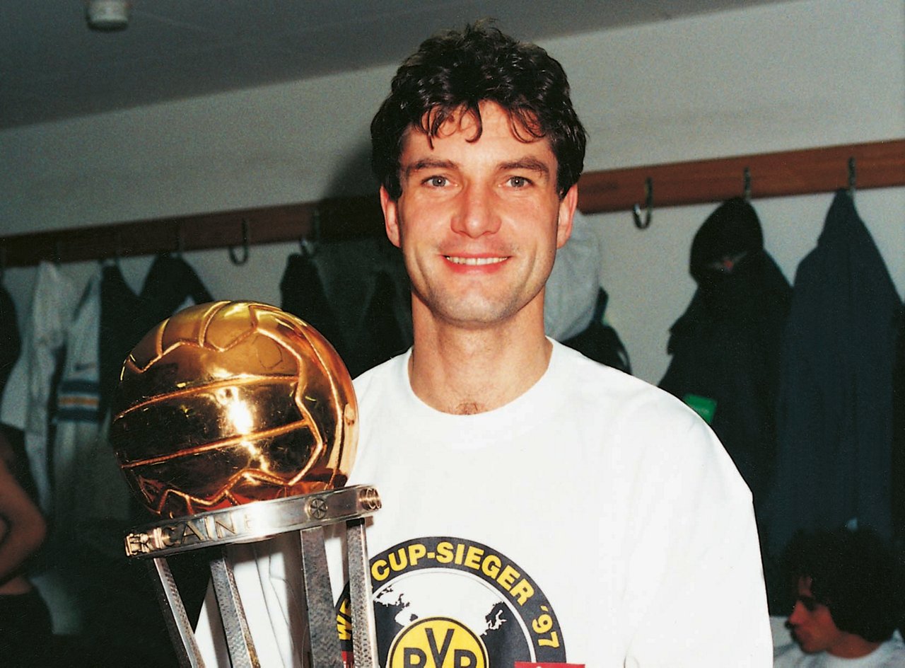 Michael Zorc holds the Intercontinental Cup.