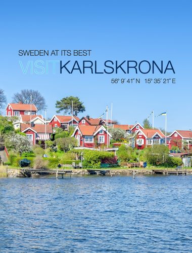 Panorama of traditional buildings with red walls and roofs on the coast of Karlskrona at Brandaholm peninsula